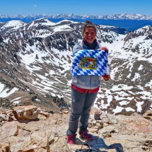 Girl from Colorado with Bavarian flag on Mount Democrat